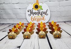 thanksgiving turkeys made out of toilet paper are sitting in front of a white brick wall