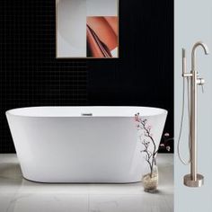 a white bath tub sitting in a bathroom next to a shower head and faucet