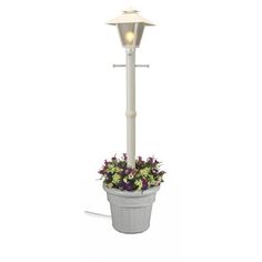 a white lamp post with flowers in the pot and lights on each pole above it