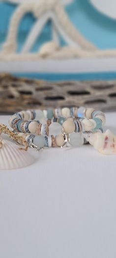 TitiTataStore.etsy.com Always FREE SHIPPING and a FREE GIFT! I Will Ship Within 24 Hours! Description: A Beautiful Set of 2 Coastal Style Beachy Bracelets.  Materials: 8mm Rondelle Blue Quartz Beads, 8mm Frosted White Sea Glass Beads, 8mm Matte Ivory Fossil Jasper Beads, 8mm Mystic Aura Quartz Beads, 8mm Natural Wood Beads, 8mm Natural White Matte Magnesite Beads, Seashells Heishi Beads, 8mm Matte Fossil Coral Riverstone, and 8mm Brushed Silver flat disc beads spacers. A Whale Tail charm adorned Bohemian Stackable Wrap Bracelet For Beach, Blue Wrap Bracelet For Beach, Hand Wrapped Wrap Bracelet For Beach, Turquoise Wrap Bracelet For Beach, Bracelets Seashell, Bracelets Beachy, Coastal Bracelet, Beachy Bracelets, Lover Birthday