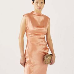 The rejina pyo delilah dress in acetate satin pink is a sleeveless midi dress with crafted from slightly wrinkled light-reflecting acetate. it features a mock neck with an invisible zipper on one side a gathered waistline for definition and an invisible side zipper as closure. this dress is designed to fit to your natural figure.    made in south korea. shell: 100% acetate. lining: 52% viscose rayon 48% polyester.    model is 173cm tall and is wearing a size uk 8.    rejina pyo is a korean desig Style Rut, Rejina Pyo, Mock Neck Dress, Sleeveless Midi Dress, Viscose Rayon, Dress Home, Mid Dresses, London Blue, Midi Dress Sleeveless