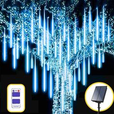 a solar powered tree with blue lights on it and an image of a cell phone