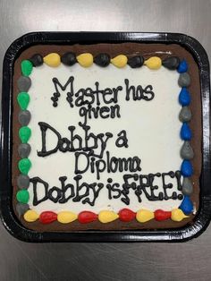 a cake that is on top of a metal surface with words written in black and white