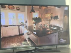 a flat screen tv sitting on top of a wooden table