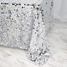 a table covered in silver sequins and black dots