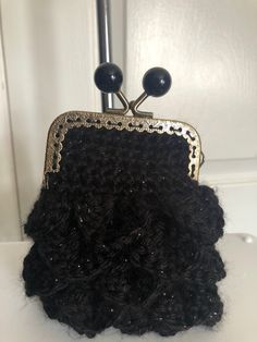 a black purse sitting on top of a white counter