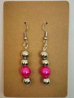 These beaded dangles show off your fun sense of style and daring color choice. Hypoallergenic Round Beaded Earrings For Party, Hypoallergenic Beaded Earrings For Party, Trendy Nickel-free Beaded Earrings With Round Beads, Hypoallergenic Round Bead Party Earrings, Hypoallergenic Round Bead Earrings For Party, Party Hypoallergenic Adjustable Beaded Earrings, Adjustable Hypoallergenic Beaded Earrings For Parties, Pink Metal Beaded Drop Earrings, Pink Metal Dangle Beaded Earrings