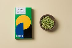 a box of matchsticks next to a bowl of peas