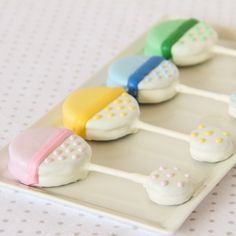 there are many different colored toothbrushes on the plate with polka dot tablecloth