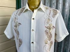 Vintage 1990's Van Heusen short sleeve shirt.  Lovely and soft and cool in cream with a delicate floral print.   Size Medium Measurements: Chest: 120 cm / 46 inches Shoulder:  48 cm / 19 inches Length:  68 cm / 27 inches Sleeve:  24 cm / 9.5 inches This item is one of a kind. BUYING VINTAGE: While all care is taken to state any obvious faults, please note that when you buy a vintage or preloved item, they may show small signs of ageing, wear and/or repair. Visit my new website   https://phoenixmenswear.com.au/ Lots of fun stuff for guys and girls...!! Please note that if you are ordering from anywhere outside of Australia please add your phone number as it is now required for delivery.  Thanks much. Summer Cream Shirt With Camp Collar, Cream Camp Collar Shirt For Summer, Cream Summer Shirt With Camp Collar, White Short Sleeve Shirt With Camp Collar For Spring, White Fitted Hawaiian Shirt Casual, Collared Cream Shirt For Summer, Cream Collared Shirt For Summer, Summer Cream Collared Shirt, White Relaxed Fit Short Sleeve Shirt For Spring