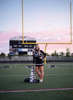 a cheerleader posing on the football field