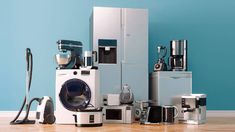 many appliances are stacked on top of each other in front of a blue wall and wooden floor