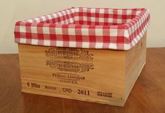 a wooden crate with a red and white checkered cover