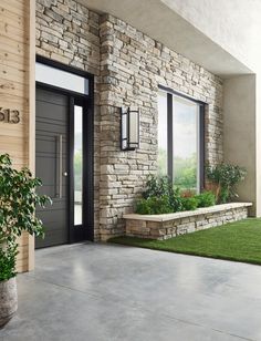 the front entrance to a house with grass and plants