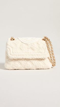 Crafted of ultra-soft cotton and wool, this convertible crossbody bag features the embroidered Double T logo. A lightweight chain and leather woven strap accompany the accessory for hands-free sophistication. Convertible chain and leather woven strap Flap with metal push-lock closure Goldtone hardware Interior back-wall zipper pocket Interior front-wall slip pocket Cotton/wool Trim: Lamb leather Lining: Polyester/rayon Tory Burch Fleming, Convertible Crossbody Bag, T Logo, Gold Bag, Fashion Portfolio, Tory Burch Handbags, Tolu, Large Shoulder Bags, Leather Weaving