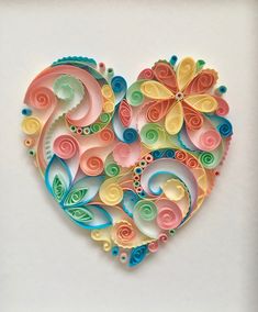 a colorful paper heart with swirls and flowers