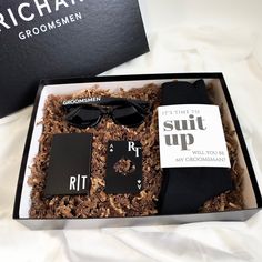 a gift box containing sunglasses, socks and other items