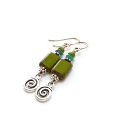 "Fun and funky earrings made with olive green glass rectangle beads that have a warm antiqued Picasso finish and an aqua glass rondelle bead on top. I added small pewter silver swirls that dangle on the end. * 2\" (5 cm) long from the top of the silver ear wire Your earrings will arrive in a gift box. Browse more of my handmade dangle earrings here: http://etsy.me/1jKWQvU SHOP ENTRANCE: http://www.etsy.com/shop/RockStoneTreasures Thanks for visiting and stop by again soon." Green Rectangular Bohemian Earrings, Green Bohemian Rectangular Earrings, Unique Green Czech Glass Beaded Earrings, Unique Green Beaded Nickel-free Earrings, Shop Entrance, Aqua Glass, Earrings Handmade Dangle, Funky Earrings, Green Earrings