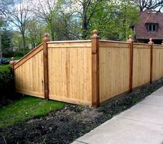 a wooden fence in front of a house