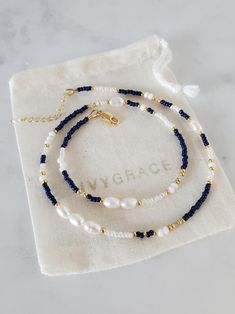 Delicate beaded necklace made with a mixture of freshwater pearls, navy blue, gold and white glass seed beads and delicate crystal beads.   The necklace fastens with an 18ct gold plated sterling silver lobster clasp and an extension chain which allows a length between 41-44cm.  The extension chain is finished with a tiny freshwater pearl. Each item I make is unique and will differ very slightly in colour/shape due to the nature of the gemstones.  My jewellery is strung on high quality, flexible Mixed Beaded Necklace, Blue And White Necklace Beads, Pearl And Silver Necklace, Blue And White Beaded Necklace, Pearl Bead Necklace, Seed Bead, Cotton Gift Bag, Handmade Jewelry Diy, Beaded Accessories