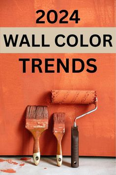 two paint rollers with the words wall color trend in black and white over an orange background