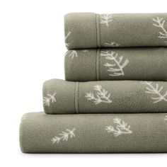 four towels stacked on top of each other with white snowflakes printed on them