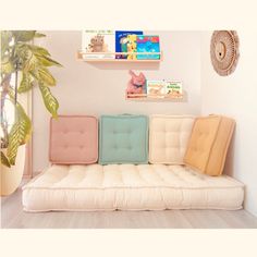 a white couch with four different colored cushions