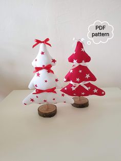 two red and white christmas trees sitting on top of a table