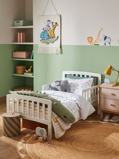 a child's bedroom with green walls and white bedding