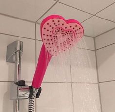 a shower head with two hearts on it