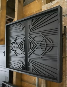 an art deco design on the side of a wall in a building with wooden floors