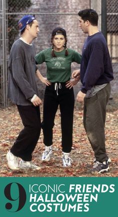 two men and a woman standing next to each other in front of a chain link fence