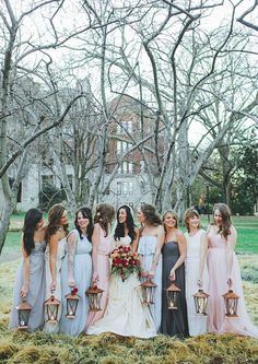 a group of women standing next to each other in front of some trees and grass