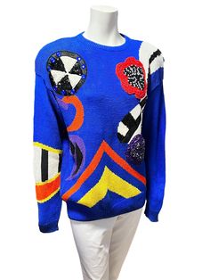 "Quintessential 80s dark navy blue knit sweater made from ramie cotton and cotton blend with 'wearable art\" stand out abstract motifs featured on the front. Crew neck and slightly oversize fit. With removable shoulder pads that are attached with velcro.  In great vintage condition, no flaws to note. Size Medium Measurements: 20\" pit to pit 28\" length 24\" sleeve" Blue Retro Sweater With Graphic Print, Retro Blue Knit Sweater, Blue Retro Knit Sweater, Vintage Blue Knit Sweater, Navy Blue Knit Sweater, 80s Memories, Abstract Motifs, 80's Fashion, 80s Sweater