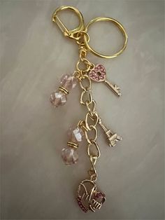 a gold key chain with charms attached to it