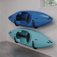 two kayaks are hanging on the wall next to each other