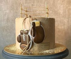 there is a cake that looks like a boxing glove and gloves on top of it