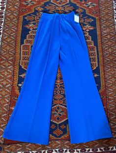 Vintage 1970's blue poly/acrylic pull on pants with elastic waist made by Upstairs Closet.  28" waist unstretched, 29" inseam, 40" length Unworn deadstock with original tags, great condition! Blue Fitted Pants With Elastic Waistband, Blue Stretch Wide Leg Pants, Fitted Blue Pants With Elastic Waistband, Blue Retro Pants For Spring, Royal Blue Stretch Bottoms For Spring, Blue Stretch Pants With Elastic Waistband, Blue Stretch Wide Leg Full Length Pants, Spring Stretch Royal Blue Bottoms, Blue Full Length Pants With Pull-on Style