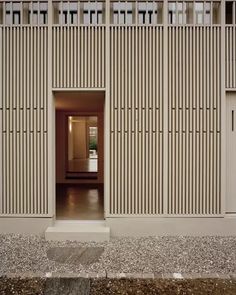 an open door leading into a room with wooden slats on the walls and floor