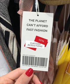 a woman's hand holding a tag that says the planet can't afford fast fashion