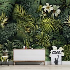 the wallpaper in this room is very large and has many tropical leaves on it