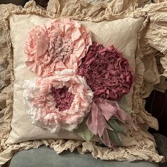 a pillow with flowers on it sitting on a chair