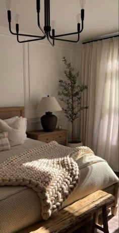 a bedroom with a large bed and a wooden bench