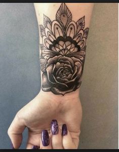 a woman's arm with a flower tattoo on it