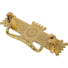 a gold colored metal object that looks like a bottle opener with four leaves on it