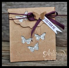 a brown card with purple ribbon and some paper butterflies on it that says, you're the night