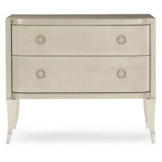 a white dresser with three drawers and two handles