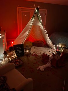 a teepee with candles and decorations on the floor