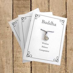 three necklaces on top of each other with the name buddha written in white ink