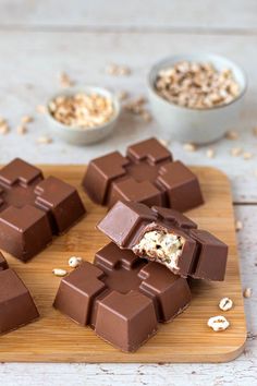 several pieces of chocolate sitting on top of a wooden cutting board